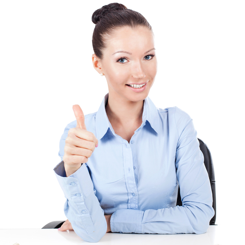 Smilling businesswoman on workplace doing gesture thumbs up