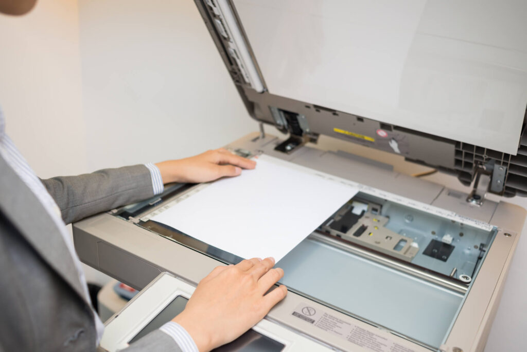 Close-up of woman copying document in the office