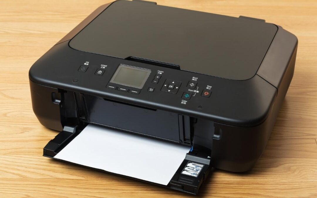 Black desktop printer on a wooden table