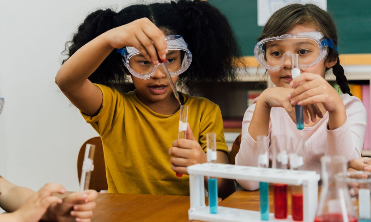 two children using a chemistry set